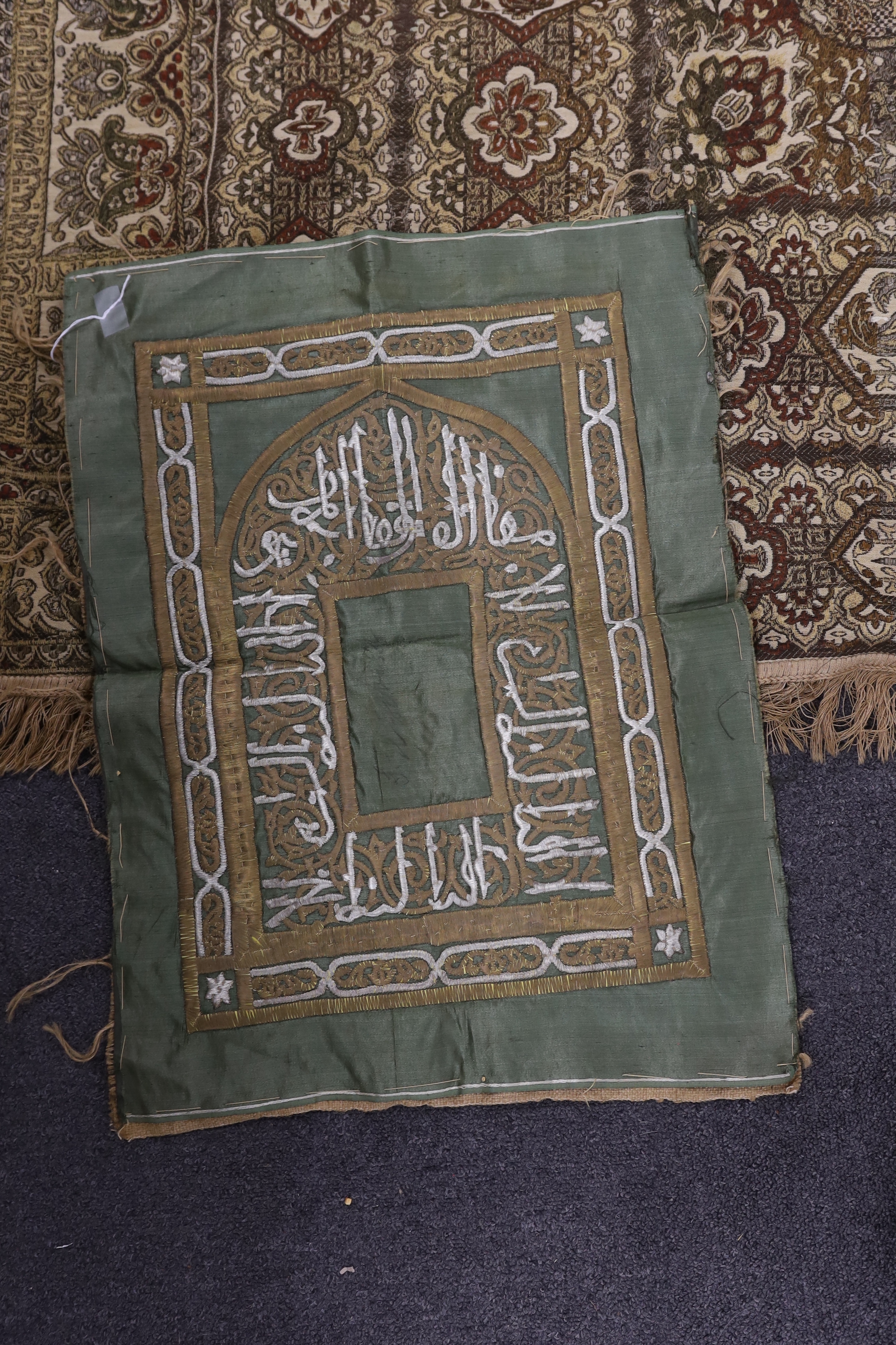 Two 19th century Indian heavy metallic thread embroideries on silk, another smaller similar panel and later 20th century machine woven fringed bedcover, two metal embroideries 53cm x 52cm
